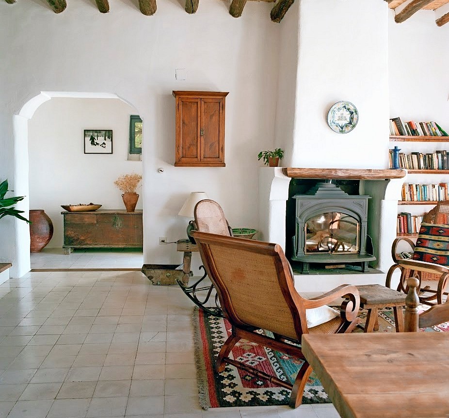 Rustic living room with fireplace and rocking chairs.
