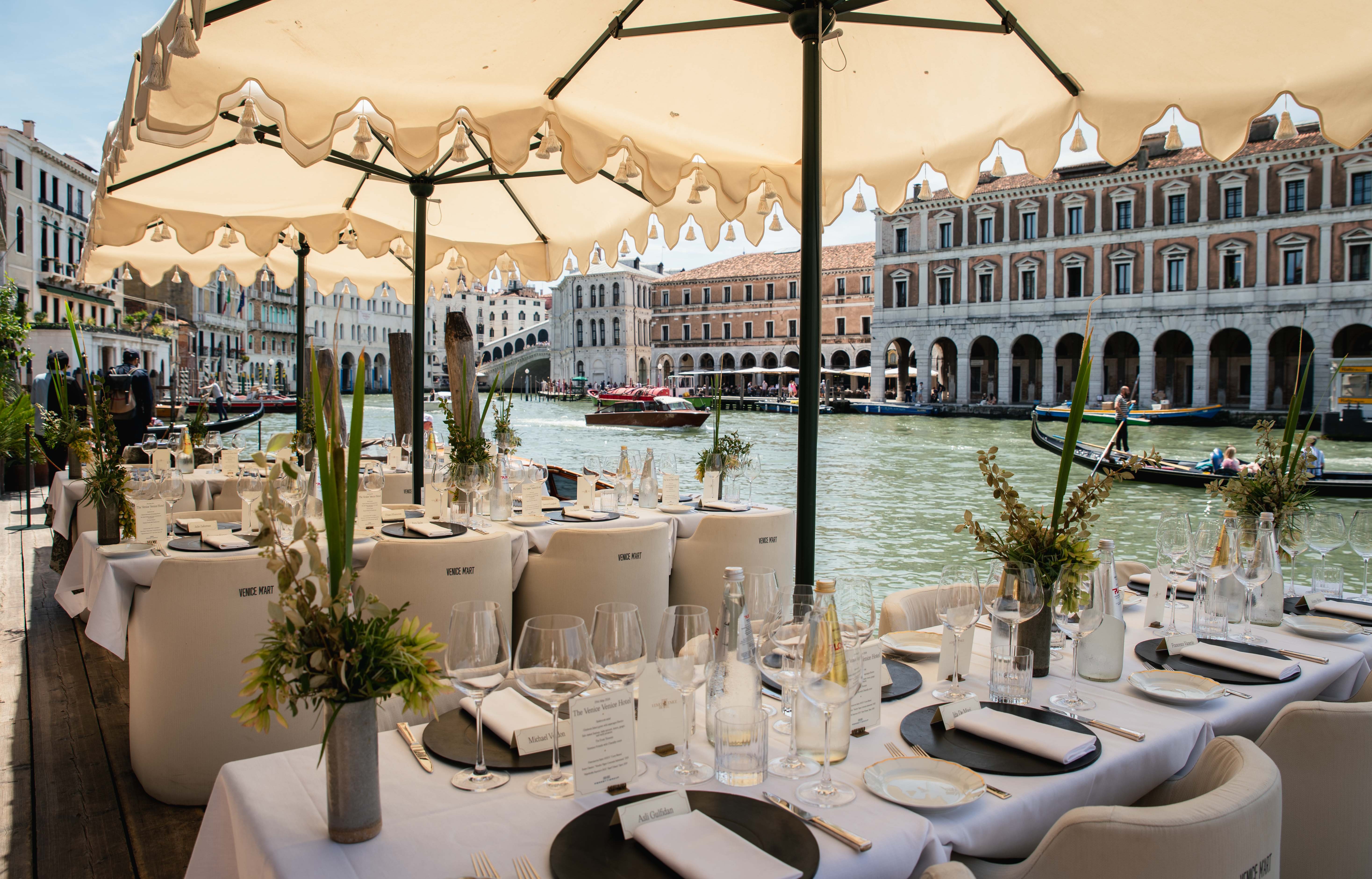 Outdoor Venice hotel dining with canal view.