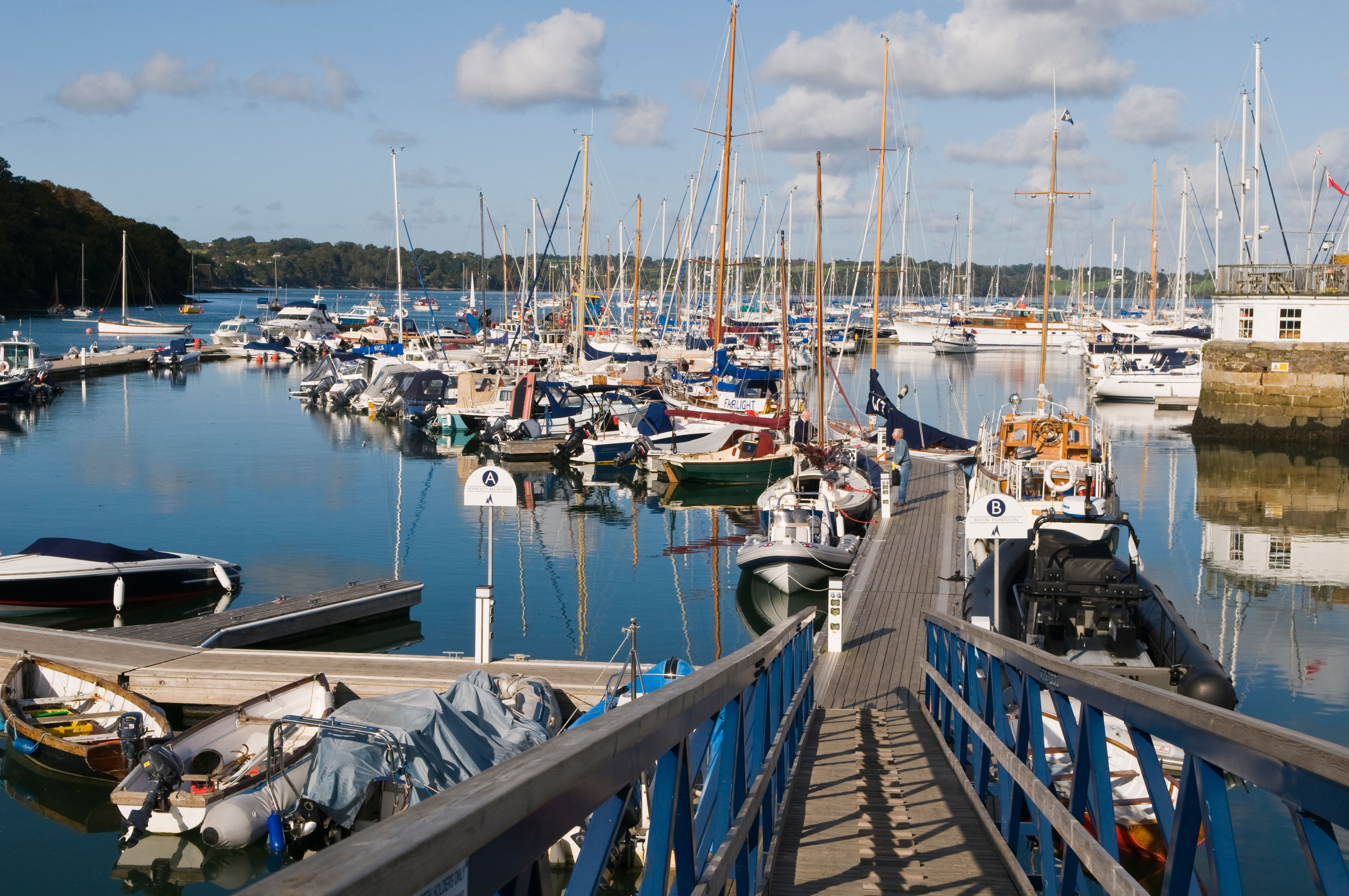 Mylor Yacht Harbour in Cornwall, UK, with many boats moored at the docks.